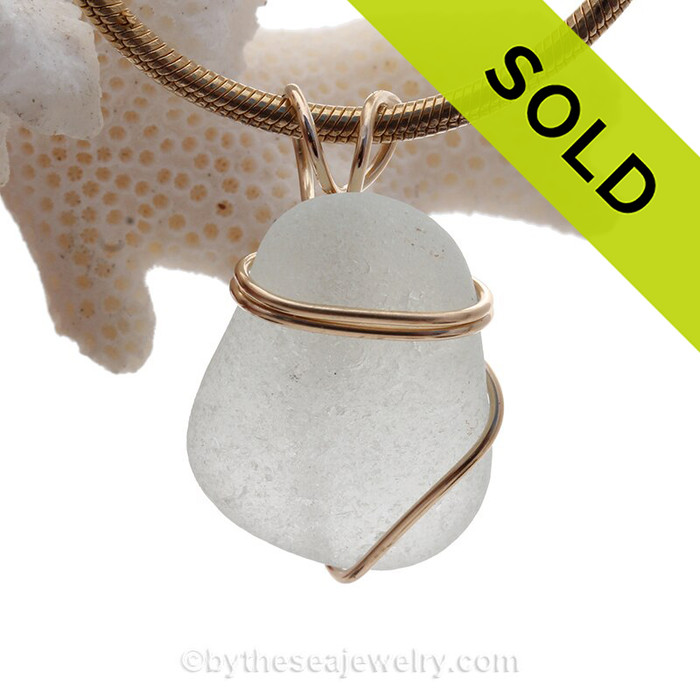 Perfect piece of lovely palest green sea glass in a simple secure rolled gold setting.