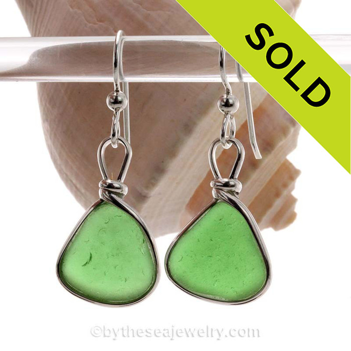 Genuine beach found Green Sea Glass Earrings in a Solid Sterling Silver Original Wire Bezel© setting.
This is a perfect sea glass in a natural state, just the way it was found on the beach!