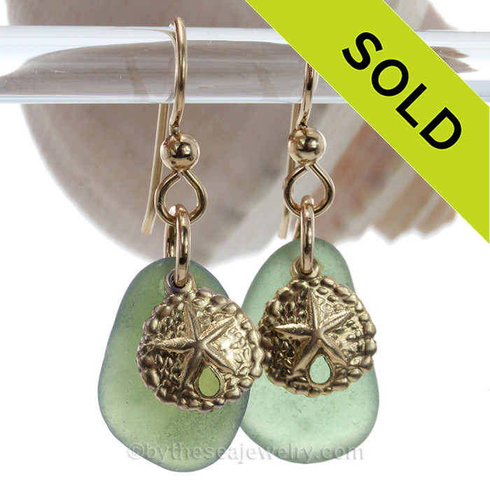 Genuine seaweed green sea glass pieces are set with 14K Goldfilled Sandollar charms on professional grade earring wires.