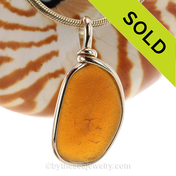 A frosty amber brown sea glass piece set in our signature 14K Rolled Gold Original Wire Bezel© setting. The sea glass piece is UNALTERED from the way it was found on the beach.! Great warm color for fall and winter!