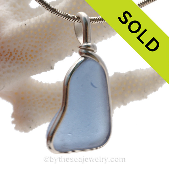 This TOP QUALITY piece of medium blue sea glass is set in our Deluxe Wire Bezel© necklace pendant setting. This setting leaves the sea glass TOTALLY UNALTERED from the way it was found on the beach. One of our last larger pieces in this color.