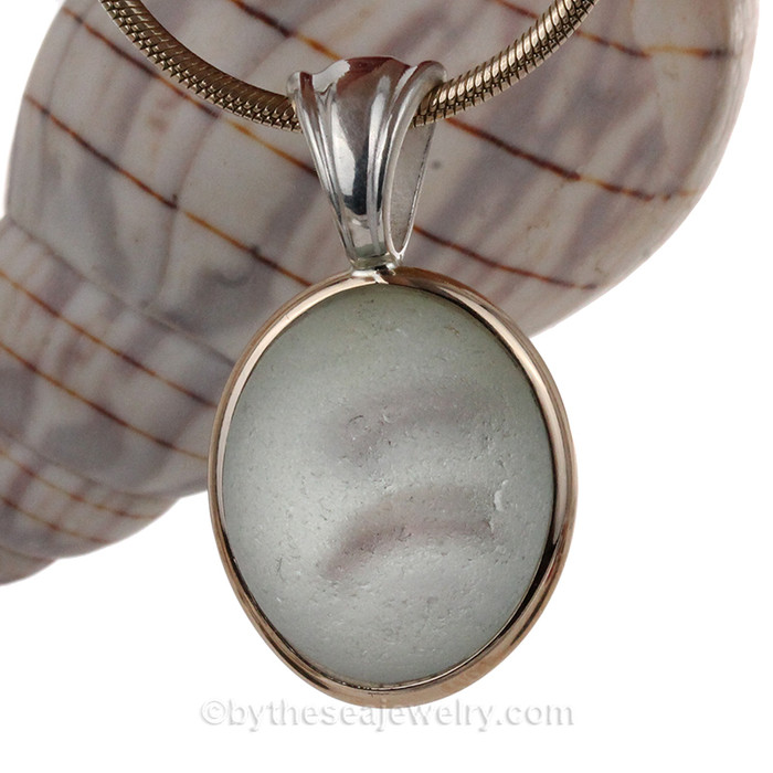 A subtle mixture of purple and a hint of gold in a base of white set in our Tiffany Deluxe Wire Bezel Pendant setting.