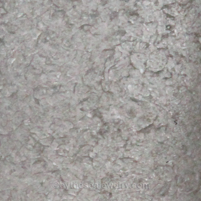 A close up of the glass in this jewelry piece.