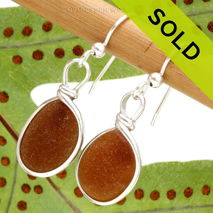 Beautiful amber brown sea glass pieces left just the way they were found on the beach in Puerto Rico are set in our Original Wire Bezel© setting. This is the EXACT pair you will receive!
Sorry these Sea Glass Earrings have been SOLD!