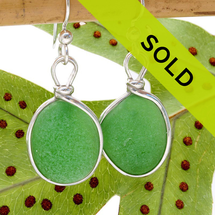 Circular green sea glass pieces UNALTERED from the way they were found on the beach set in our Original Wire Bezel© setting.
Sorry this pair has sold!