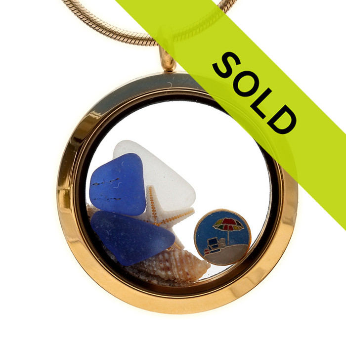 Blue and white sea glass combined with a starfish, shell and real beach sand and finished with a beachy token inside this goldtone magnetic locket.
The is the EXACT locket you will receive!