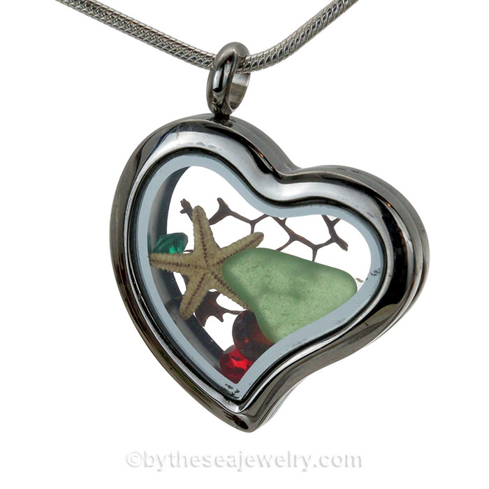 Beautiful pieces of Genuine Green Sea Glass combined with a Real Starfish. Finished with vivid Ruby Red crystal gems in this heart locket necklace.