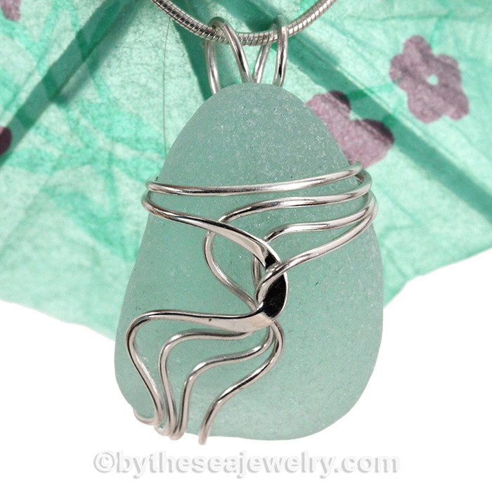 A nice TOP QUALITY piece of  pale aqua green sea glass set in our signature Waves© setting in sterling silver.