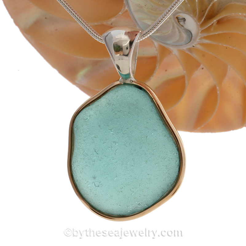 blue sea glass pendant in tiffany deluxe (gold and silver) bezel setting