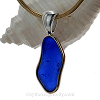 blue sea glass pendant in tiffany deluxe (gold and silver) bezel setting