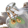 Perfect yellowy seafoam green sea glass pieces set with goldfilled sun charms for a lovely lightweight pair of earrings.