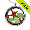Genuine green sea glass pieces combined with a real starfish, vivid red gems and real beach sand in this 35MM stainless steel waterproof locket.