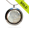 Genuine Sea Glass Locket with a real baby Sandollar and Beach Sand, and brightened up with CZ crystal gems and Pearls. 
Diamonds are the April Birthday gemstones, Pearl are for June.
SOLD - Sorry this Sea Glass Jewelry Locket is NO LONGER AVAILABLE!