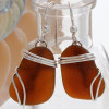 Larger chocolate brown sea glass earrings in triple solid sterling silver setting.