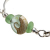 A detail of this sea glass bangle bracelet shows you the top quality of the seafoam sea glass and the beauty of the handmade bead.