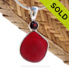 This beautiful ULTRA RARE Ruby Red sea glass piece is set in our Deluxe Wire Bezel© pendant setting with a genuine Garnet Brilliant Cut gem.
Sorry this Sea Glass Jewelry selection has been SOLD!