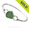 A nice piece of yellowy seafoam green sea glass set in fine and sterling silver in a classic bangle bracelet.
Sorry this piece of Sea Glass Jewelry has been sold!