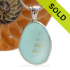 A wonderful shaped bottle bottom piece of Aqua Blue sea glass in our In Our Deluxe Sterling Wire Bezel© necklace pendant.