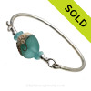 VIVID Aqua Genuine Sea Glass Bangle Bracelet set with a handmade lampwork glass wave bead in aqua with sterling end beads on a solid sterling full round premium bangle bracelet.
SOLD - Sorry this Sea Glass Bangle Bracelet is NO LONGER AVAILABLE!