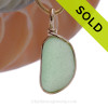 This is a beautiful thick and ROUND Seaham Seafoam Sea Glass set in our Original Wire Bezel© pendant setting with 14K rolled gold.