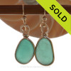 A stunning pair of deep aqua green or Turquoise Sea Glass Earrings in gold Bezel.