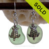 Natural beach found unusual green sea glass pieces are set with solid sterling Sea Turtle charms and are presented on sterling silver fishook earrings.