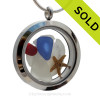 Cobalt Blue and a small piece of Ruby Red Sea Glass in a crystal and stainless steel locket combined with a baby starfish, sandollar.  
SOLD - Sorry this Sea Glass Jewelry selection is NO LONGER AVAILABLE!