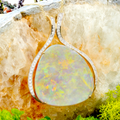 *A RAINBOW HALO 18KT GOLD & DIAMOND WHITE OPAL PENDANT