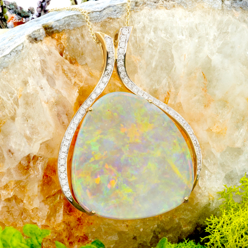 *A RAINBOW HALO 18KT GOLD & DIAMOND WHITE OPAL PENDANT
