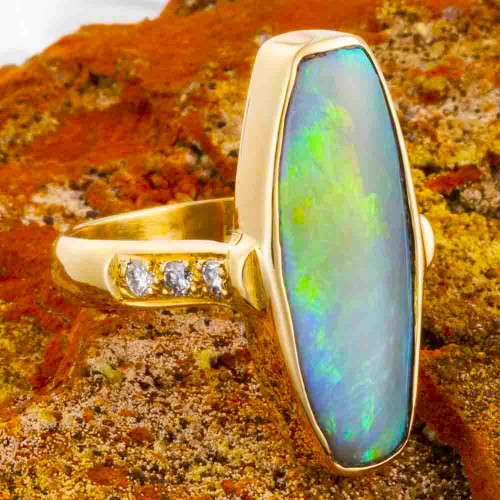 * A MINE LIGHT 14KT YELLOW GOLD & DIAMOND AUSTRALIAN OPAL RING