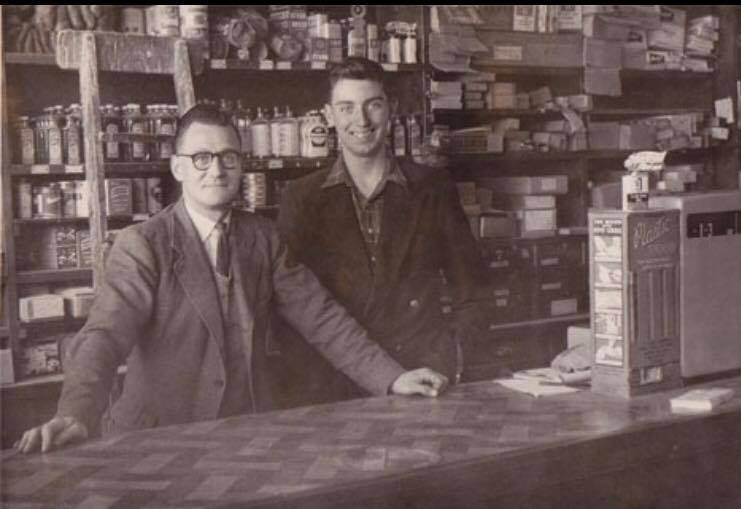 Old photo of two gentlemen in traditional hardware store