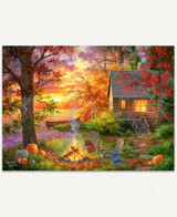  Sunset Serenity puzzle paints the perfect picture of autumn at a cabin by the lake. A campfire is ablaze as the sun is setting in the background, reflecting off of the lake. 