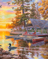  Close-up of Canoe Camp Buffalo wooden jigsaw puzzle unveiling an autumn evening of a lake view property. Two people take a canoe ride on the lake as the sun sets, reflecting vibrant pastel colors on the water. A moose stands on the shore line watching the boat as ducks swim near canoes lining the perimeter of a boat dock. Adirondack chairs surround a fire pit off the side of a cabin. 