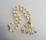Crown Trifari Suspended Animation Faux Ivory and Gold Textured Beads Tassel Necklace 1960s