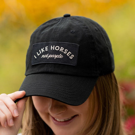 Black barn hat with embroidered “I Like Horses Not People” patch and curved brim