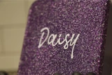 Close-up of a UV printed name on a purple glitter bento lid