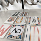 Printed Retro Brights classroom printables laid out on a table, ready to cut and laminate