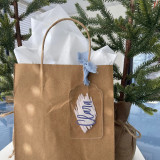 Acrylic name tag tied to a kraft gift bag