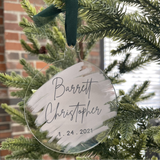 Close-up of a name ornament with a birthdate on a tree