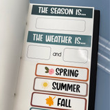 Earth Tones weather and seasons whiteboard clings stored on a Binder Ready sheet in a three-ring binder