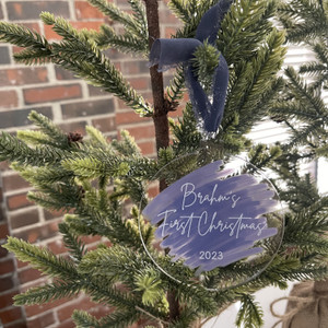 Baby's First Christmas acrylic ornament with a purple brushstroke and year