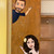 Custom Bitmoji decals waving from a classroom door