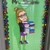 Teacher Bitmoji decal holding books on a classroom door with a name header