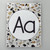 Printed Modern Terrazzo Aa alphabet poster with a round terrazzo frame
