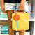 Sunrise OmiePod on a yellow OmieBox handle