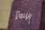 Close-up of a UV printed name on a purple glitter bento lid