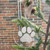 White paw print ornament with a pet name and a taupe ribbon