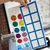Rainbow ten frame whiteboard cling with counters up close, showing the reusable static cling