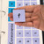 Hand holding a letter cling from the Word Builder set to show the reusable static cling