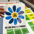 Rainbow Let's Grow Together flower goal tracker clings held up to show the reusable static cling